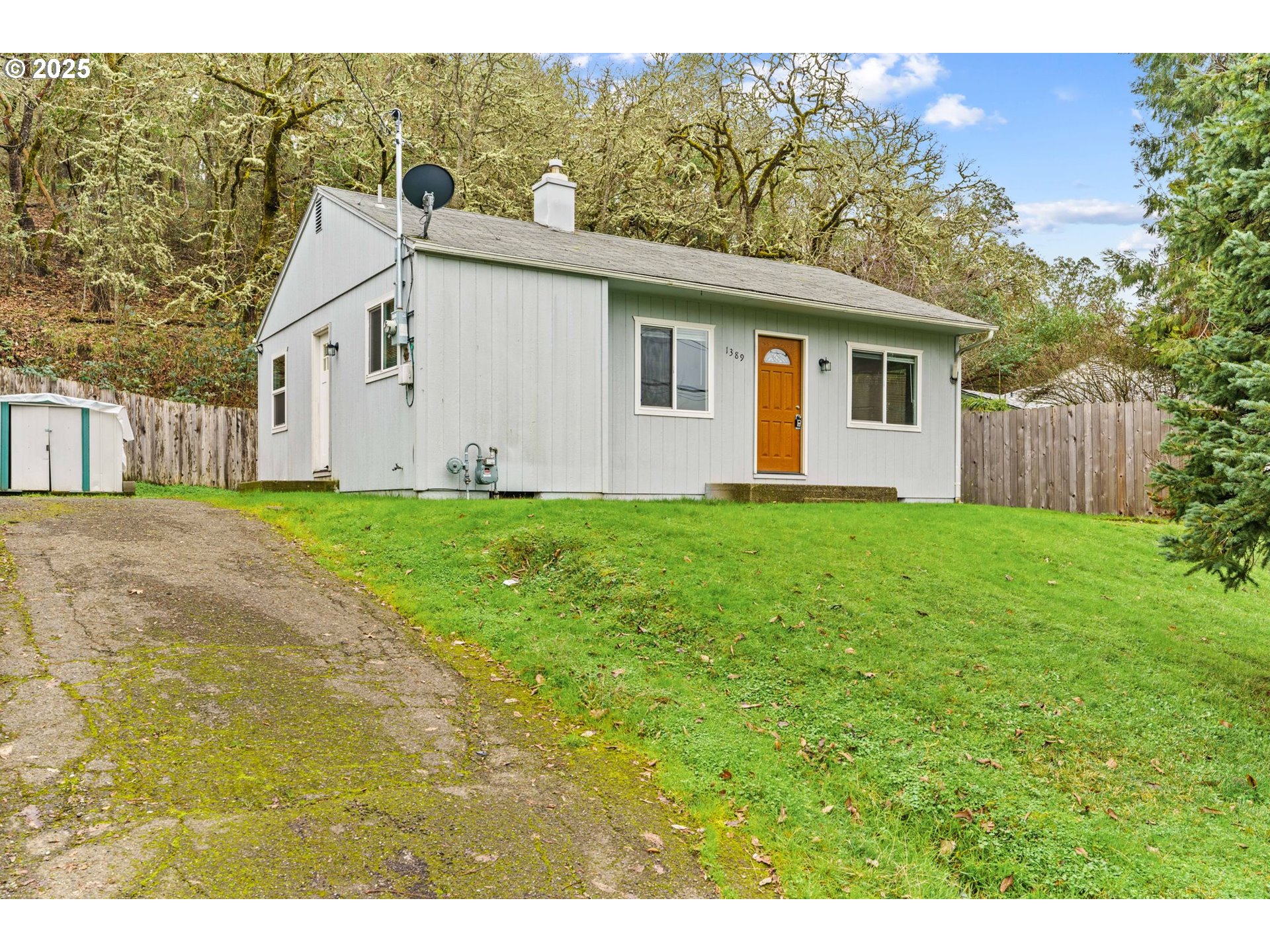 1389 Northeast Brooklyn Avenue Roseburg, OR 97470 - Photo 2 of 19 a view of a yard in front of a house with large trees