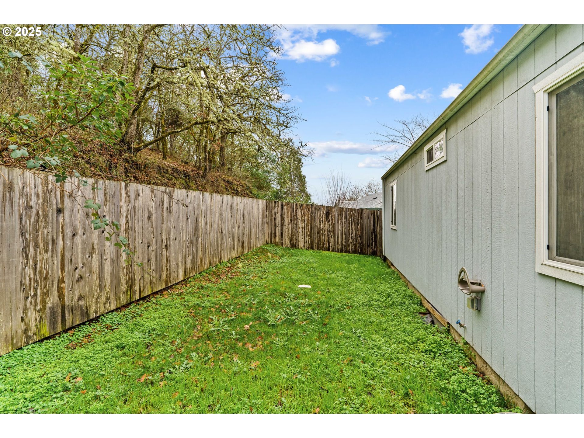 1389 Northeast Brooklyn Avenue Roseburg, OR 97470 - Photo 4 of 19 a view of a backyard with wooden fence