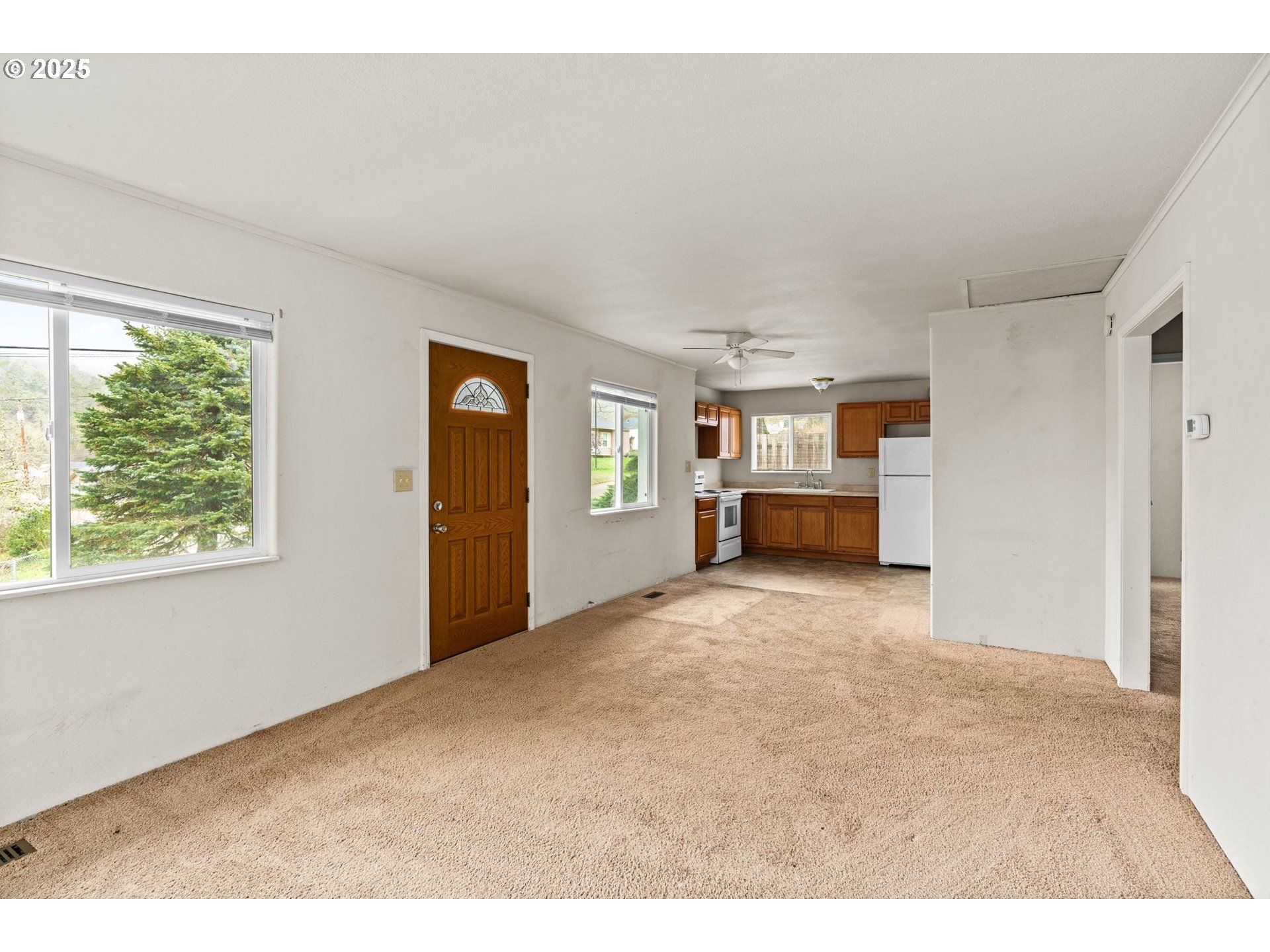 1389 Northeast Brooklyn Avenue Roseburg, OR 97470 - Photo 6 of 19 a view of an empty room with a window and fireplace