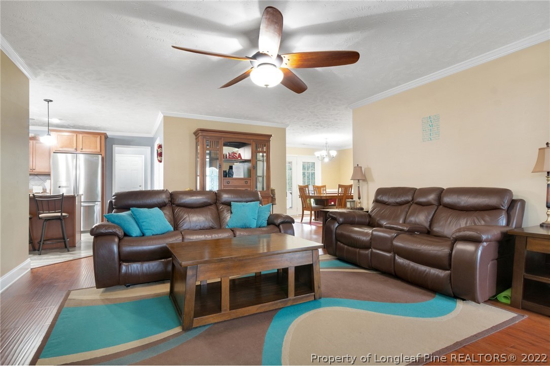 274 Deaton Road Raeford, NC 28376 - Photo 13 of 49 a living room with furniture ceiling fan and a rug