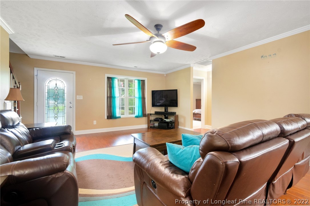 274 Deaton Road Raeford, NC 28376 - Photo 14 of 49 a living room with furniture a ceiling fan and a large window