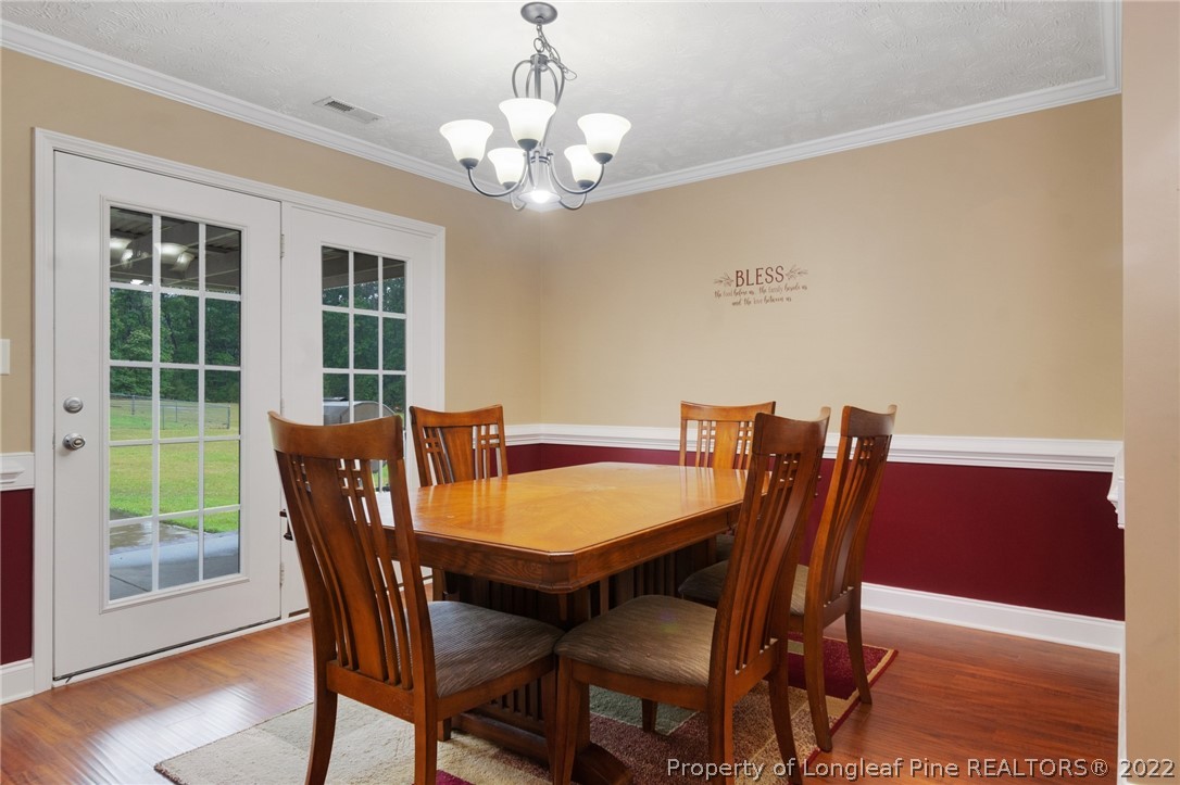 274 Deaton Road Raeford, NC 28376 - Photo 15 of 49 a view of a dining room with furniture window and wooden floor