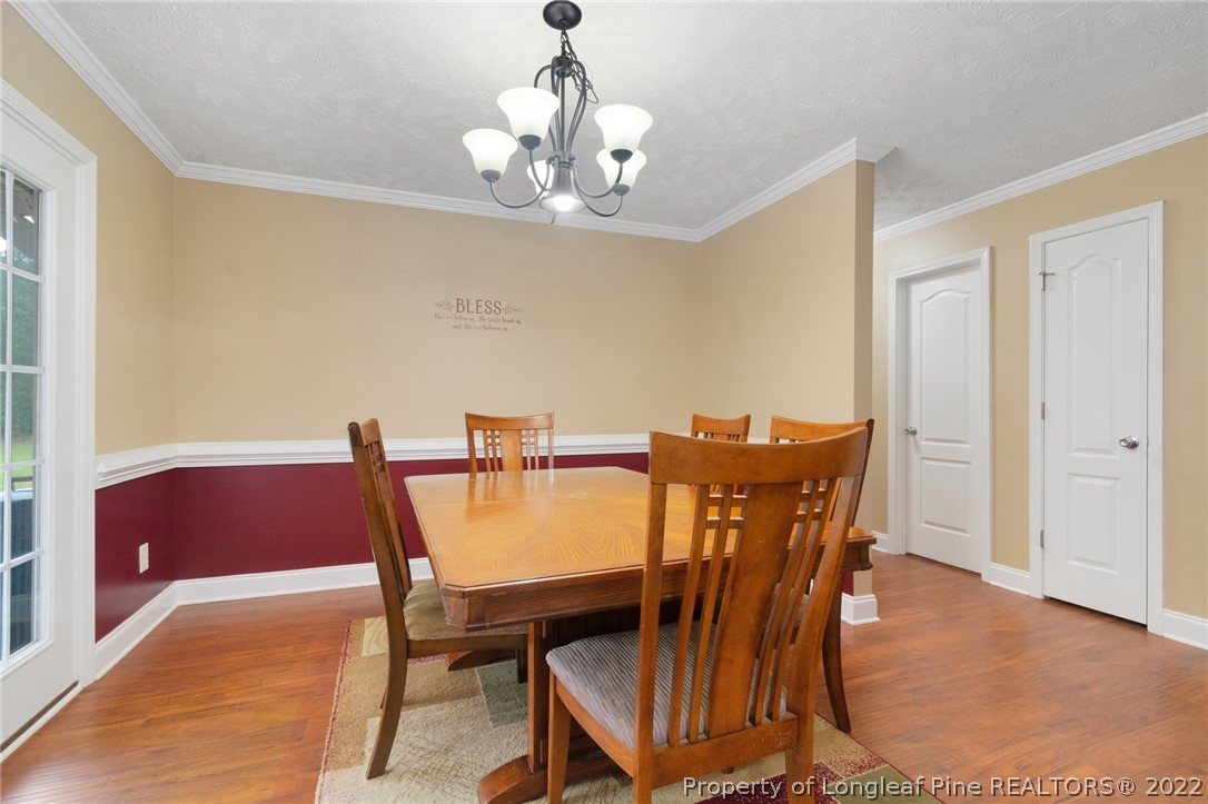 274 Deaton Road Raeford, NC 28376 - Photo 16 of 49 a view of a dining room with furniture and chandelier