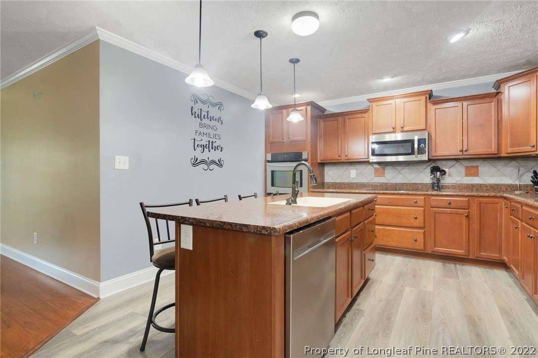 274 Deaton Road Raeford, NC 28376 - Photo 17 of 49 a kitchen with a sink a counter space appliances and cabinets