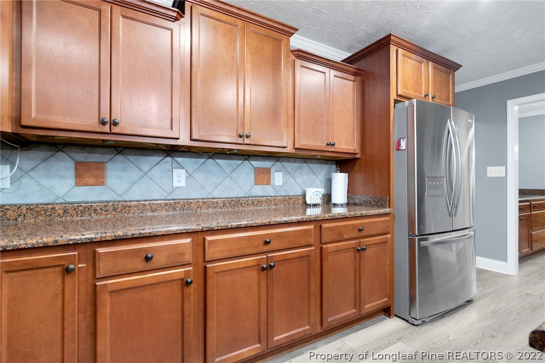 274 Deaton Road Raeford, NC 28376 - Photo 20 of 49 a kitchen with stainless steel appliances granite countertop a refrigerator and cabinets
