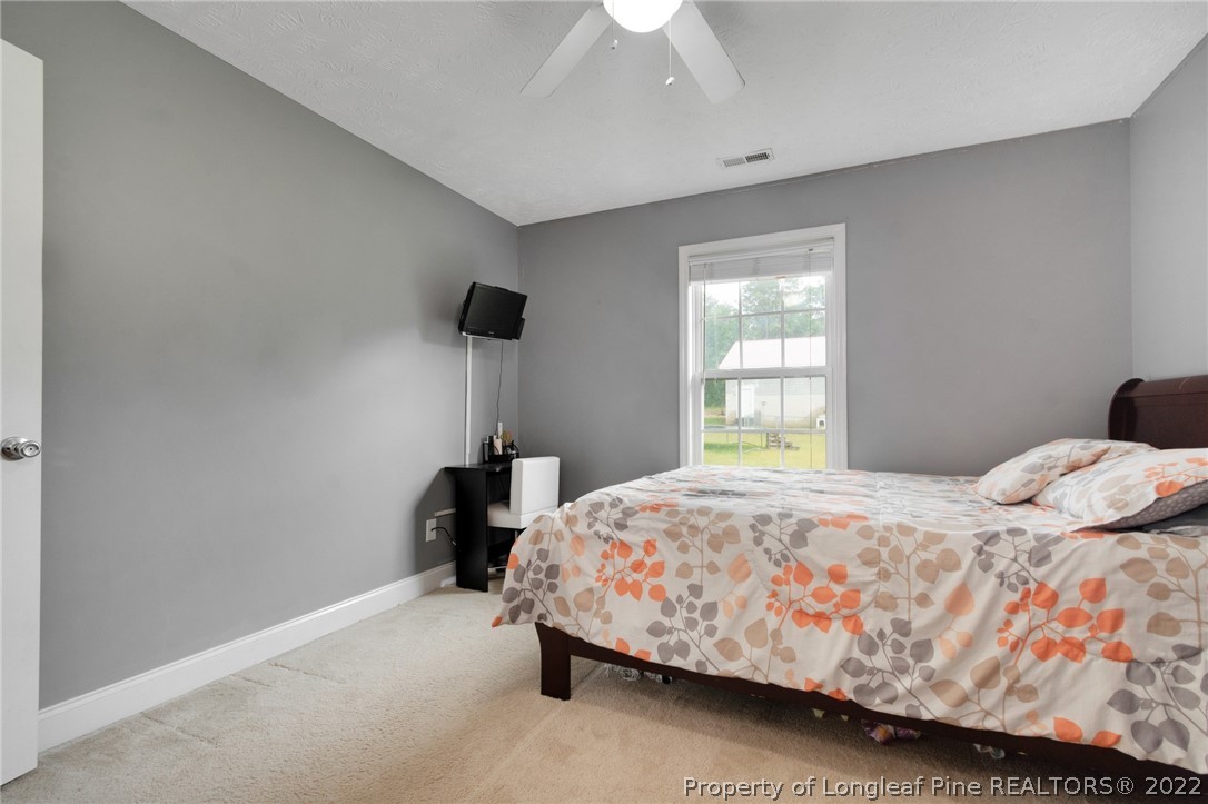 274 Deaton Road Raeford, NC 28376 - Photo 24 of 49 a bedroom with a bed and a window