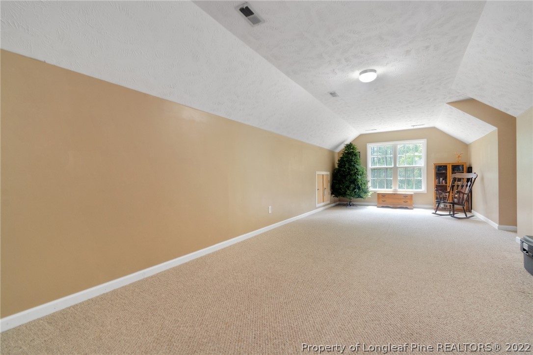 274 Deaton Road Raeford, NC 28376 - Photo 31 of 49 a view of a big room with windows and chandelier fan