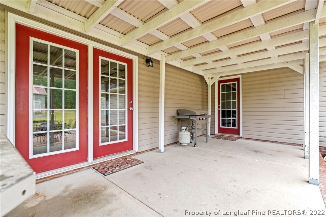 274 Deaton Road Raeford, NC 28376 - Photo 35 of 49 a view of a porch with a table and chairs and iron fence