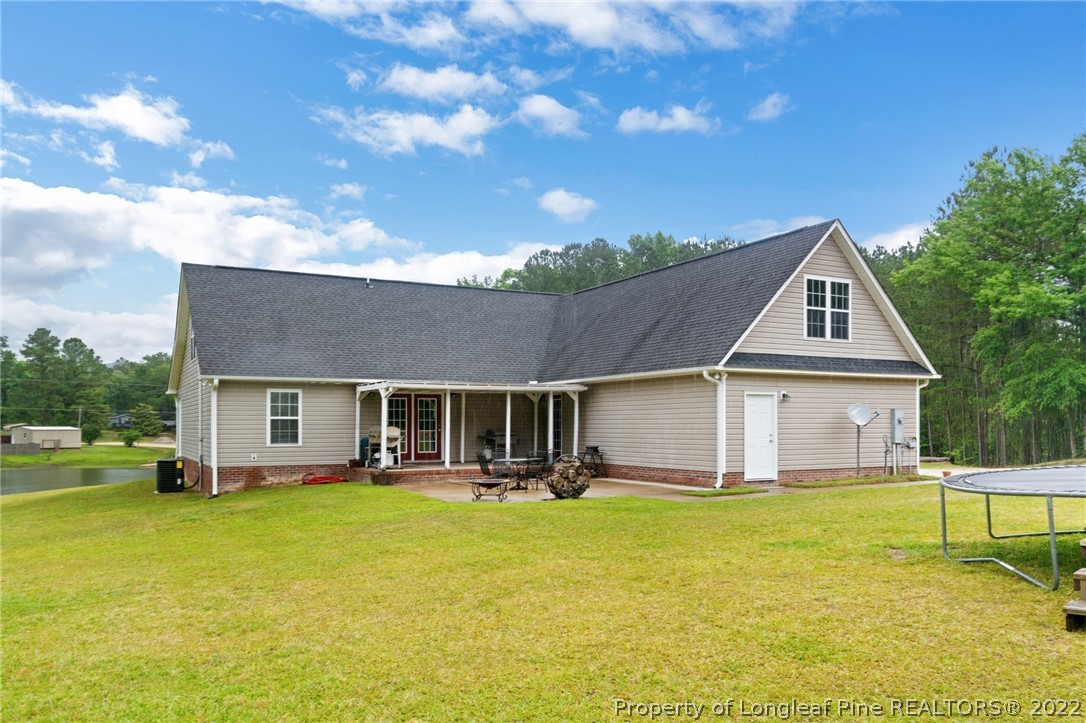 274 Deaton Road Raeford, NC 28376 - Photo 39 of 49 a front view of house with yard and swimming pool