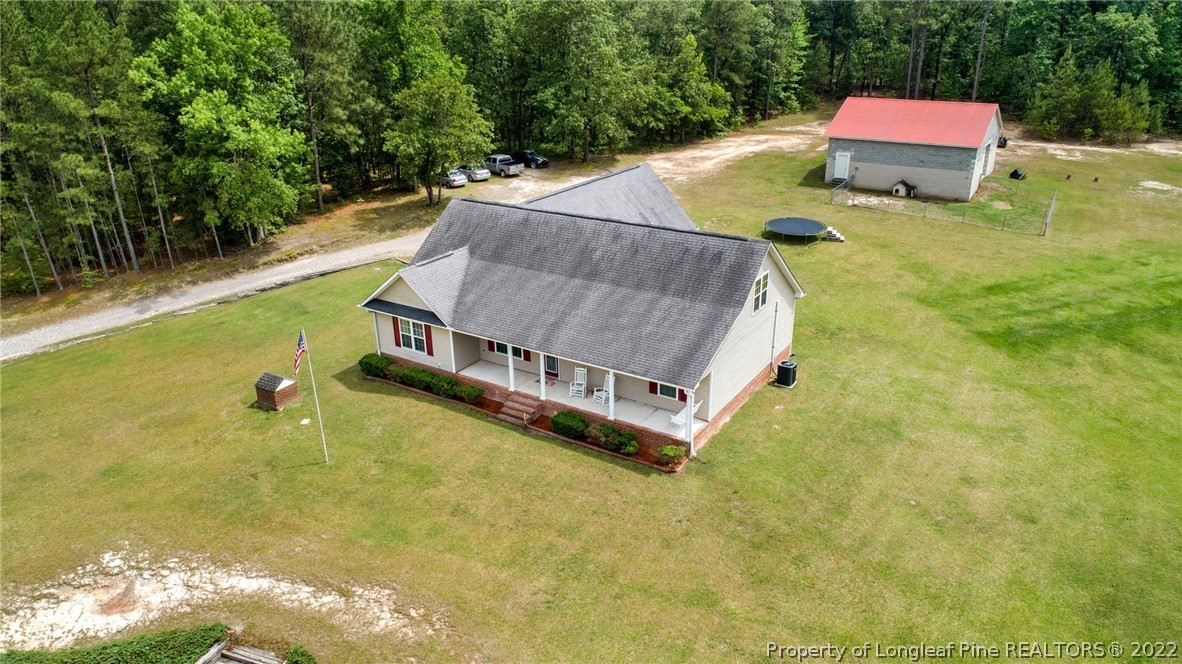 274 Deaton Road Raeford, NC 28376 - Photo 42 of 49 a aerial view of a house with swimming pool and tennis court
