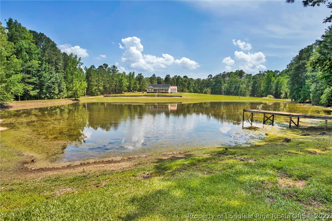 274 Deaton Road Raeford, NC 28376 - Photo 9 of 49 a view of a lake with a yard