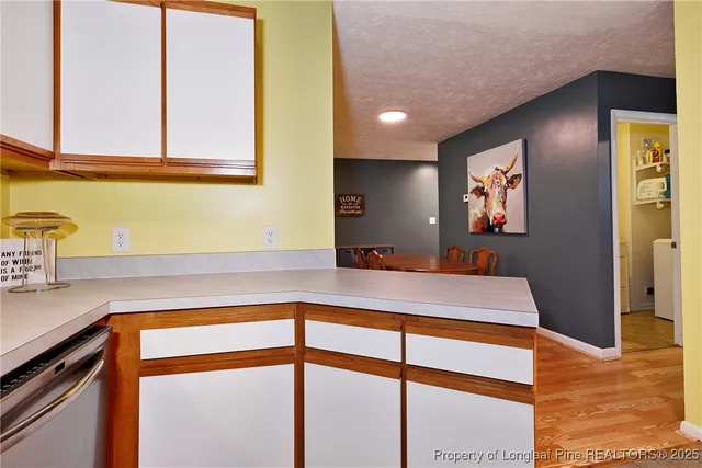 a kitchen with stainless steel appliances granite countertop a sink and a microwave