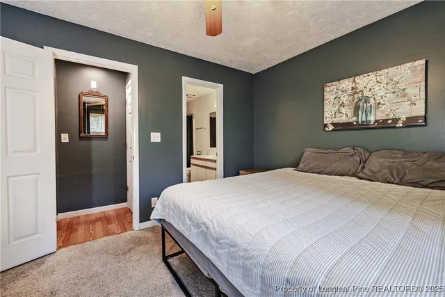 a bedroom with a bed and a painting on the wall