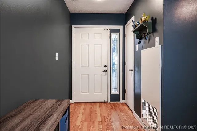 a view of a bedroom with wooden floor and closet