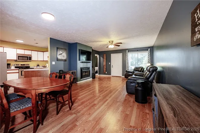 a dining room with furniture and wooden floor