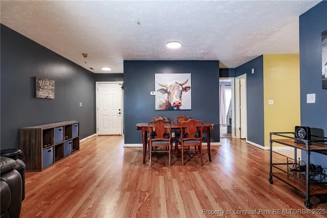 a dining room with furniture and wooden floor