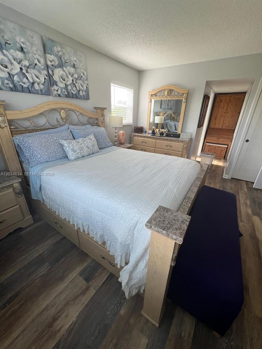 9880 Marina Boulevard, Unit 1516 Boca Raton, FL 33428 - Photo 12 of 32 a bedroom with bed and window
