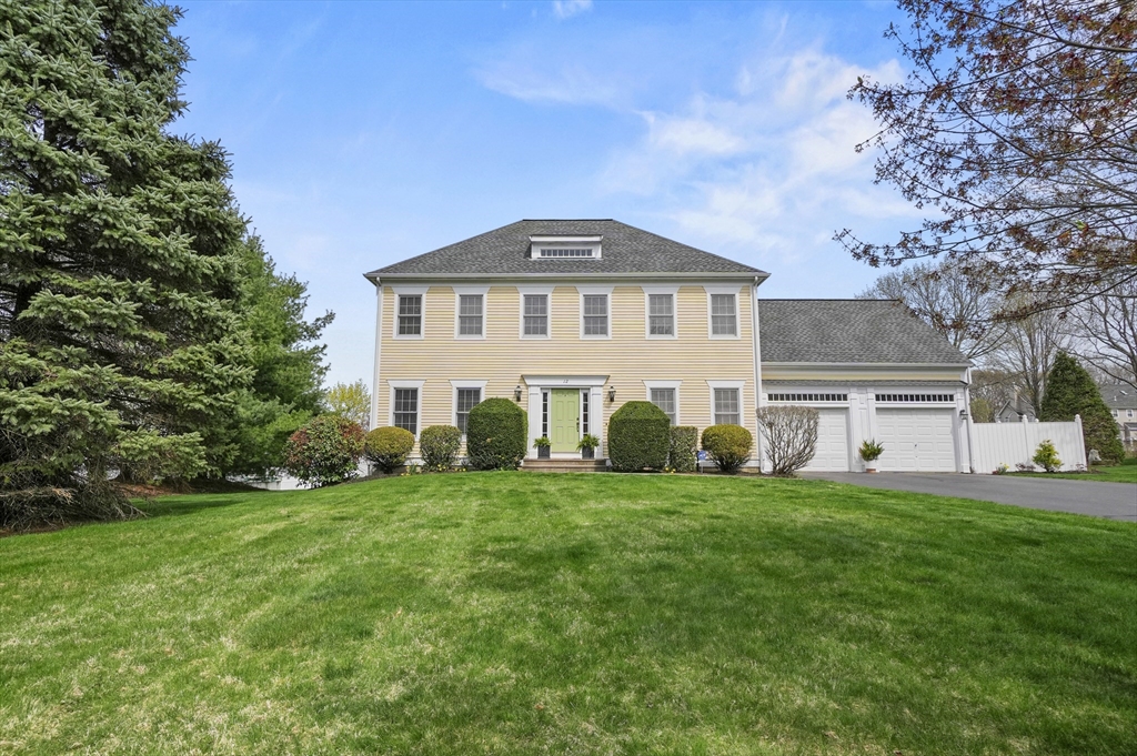 a view of a house with a big yard and large trees