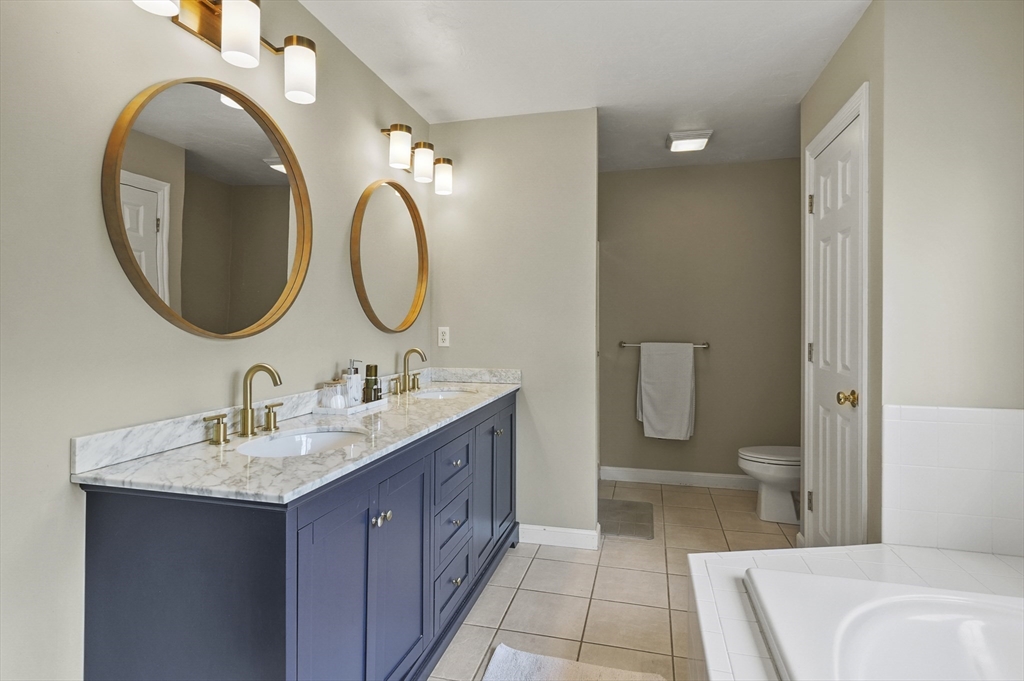 12 Peach Tree Drive Sutton, MA 01590 - Photo 19 of 37 a bathroom with a granite countertop sink and a mirror