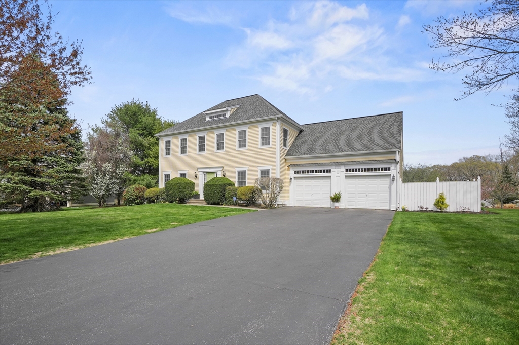 12 Peach Tree Drive Sutton, MA 01590 - Photo 2 of 37 a front view of a house with a yard and garage