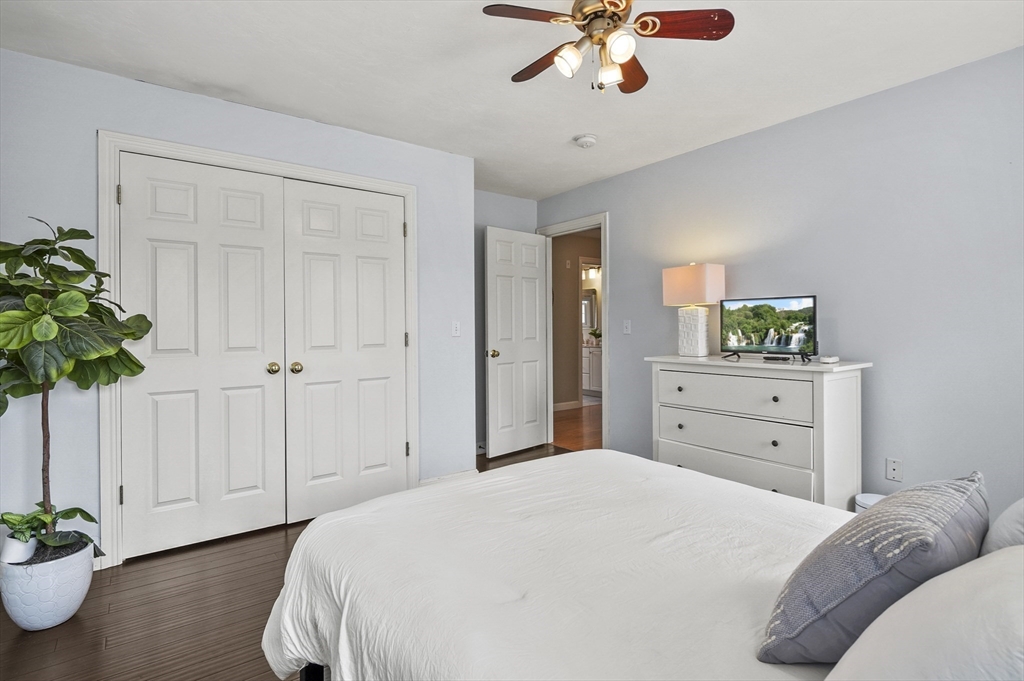 12 Peach Tree Drive Sutton, MA 01590 - Photo 27 of 37 a bedroom with a bed and a chandelier