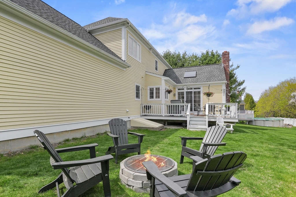 12 Peach Tree Drive Sutton, MA 01590 - Photo 35 of 37 a view of a chair and table in backyard of the house