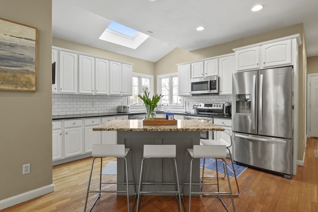 12 Peach Tree Drive Sutton, MA 01590 - Photo 5 of 37 a kitchen with granite countertop a refrigerator stove microwave and cabinets