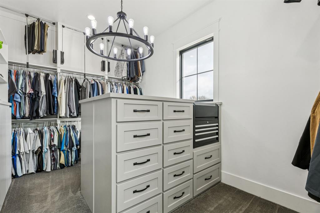 2577 Lone Star Road Celina, TX 75009 - Photo 15 of 40 a view of walk in closet with clothes and shoes