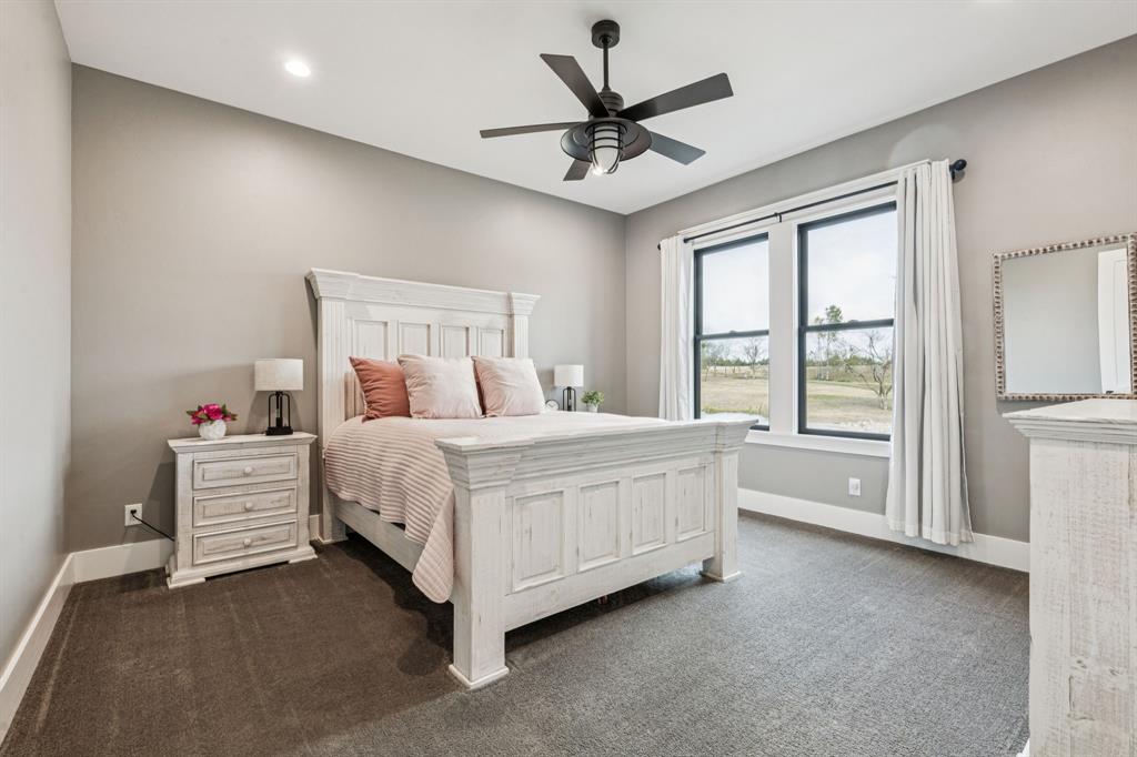 2577 Lone Star Road Celina, TX 75009 - Photo 16 of 40 a bed room with a bed and a ceiling fan