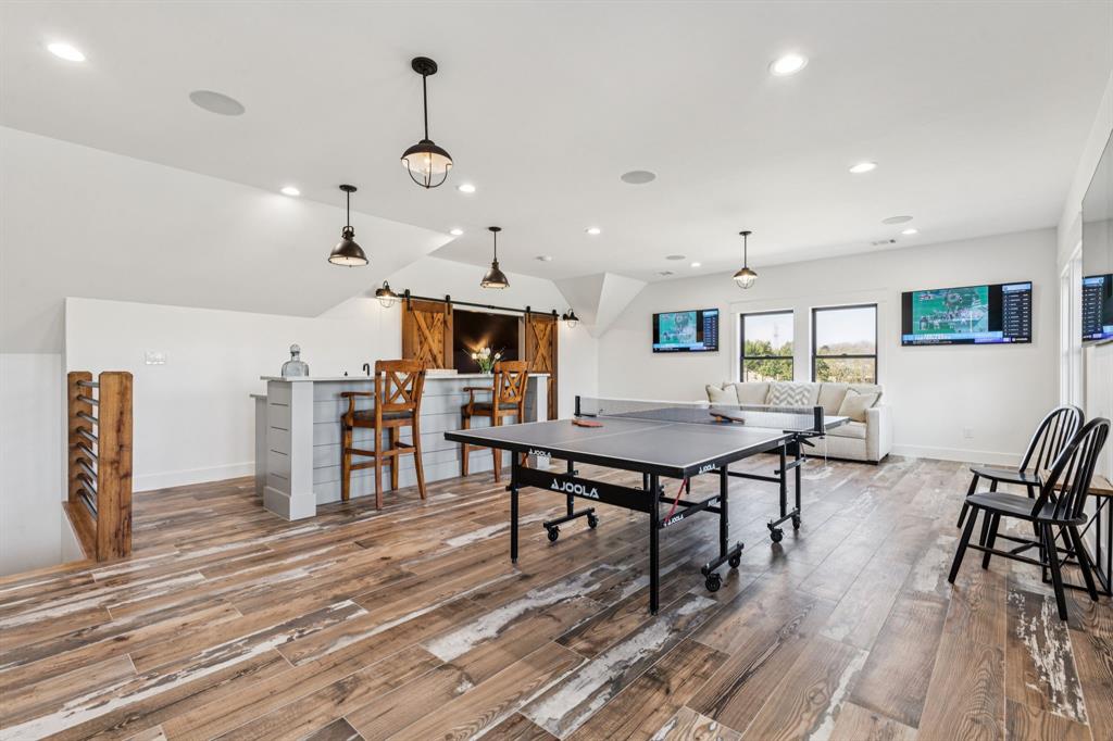 2577 Lone Star Road Celina, TX 75009 - Photo 19 of 40 a view of a dining room with furniture and wooden floor