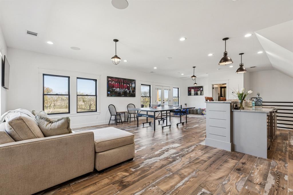 2577 Lone Star Road Celina, TX 75009 - Photo 20 of 40 a living room with furniture and a dining table with kitchen view