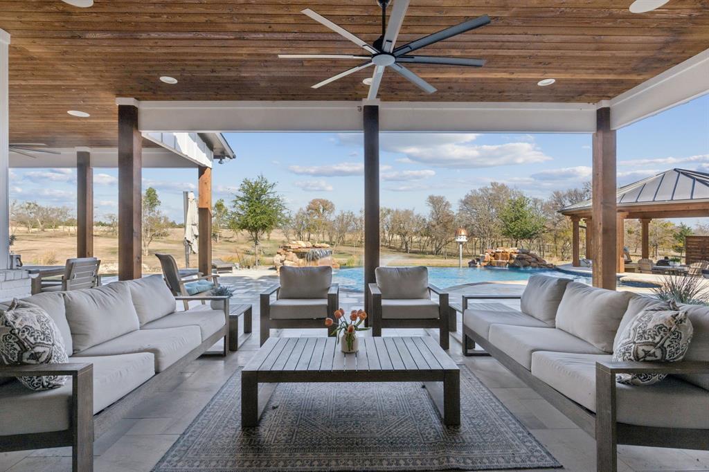 2577 Lone Star Road Celina, TX 75009 - Photo 26 of 40 a living room with furniture and a floor to ceiling window
