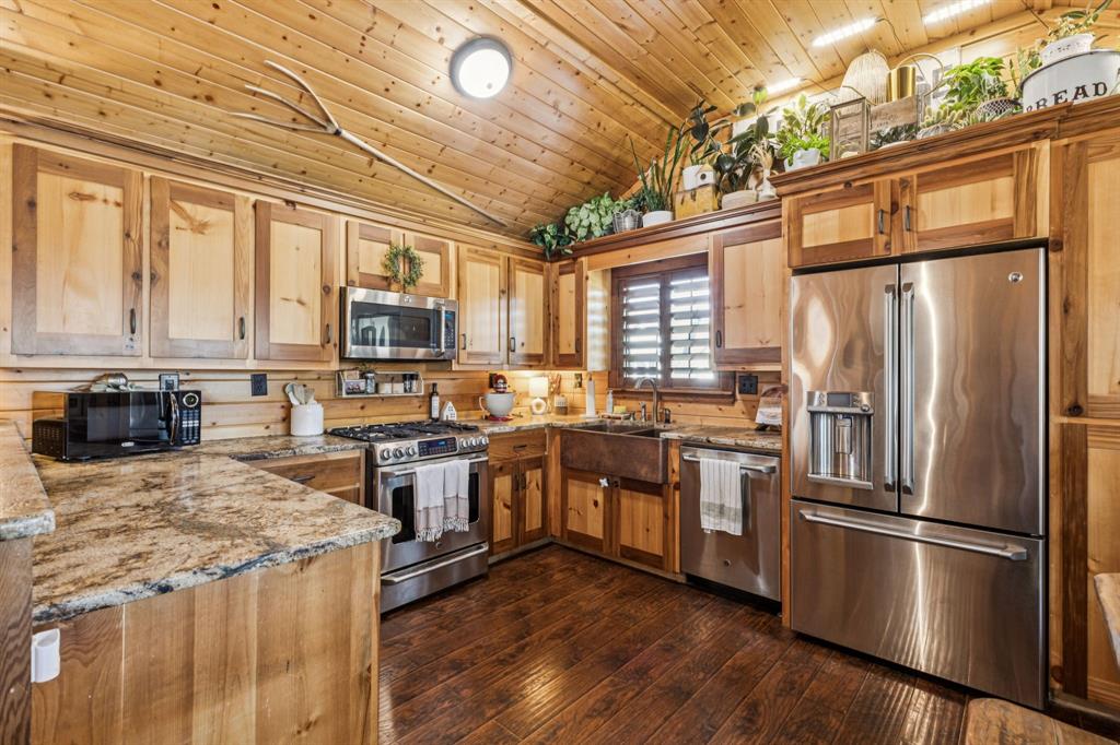 2577 Lone Star Road Celina, TX 75009 - Photo 34 of 40 a kitchen with stainless steel appliances granite countertop a refrigerator a stove top oven a sink and dishwasher