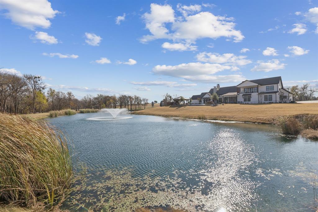 2577 Lone Star Road Celina, TX 75009 - Photo 38 of 40 a view of a lake with houses in the background