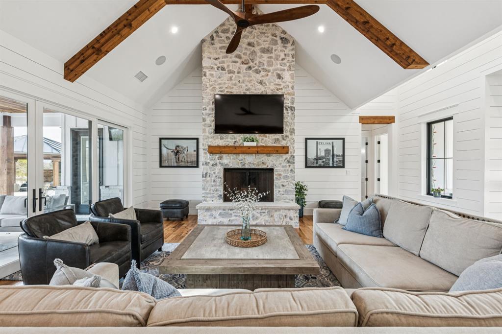 2577 Lone Star Road Celina, TX 75009 - Photo 4 of 40 a living room with furniture a flat screen tv and a fireplace
