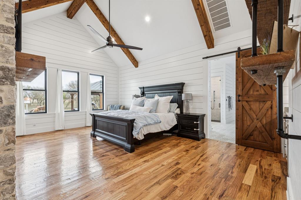 2577 Lone Star Road Celina, TX 75009 - Photo 9 of 40 a spacious bedroom with a bed and a wooden floor