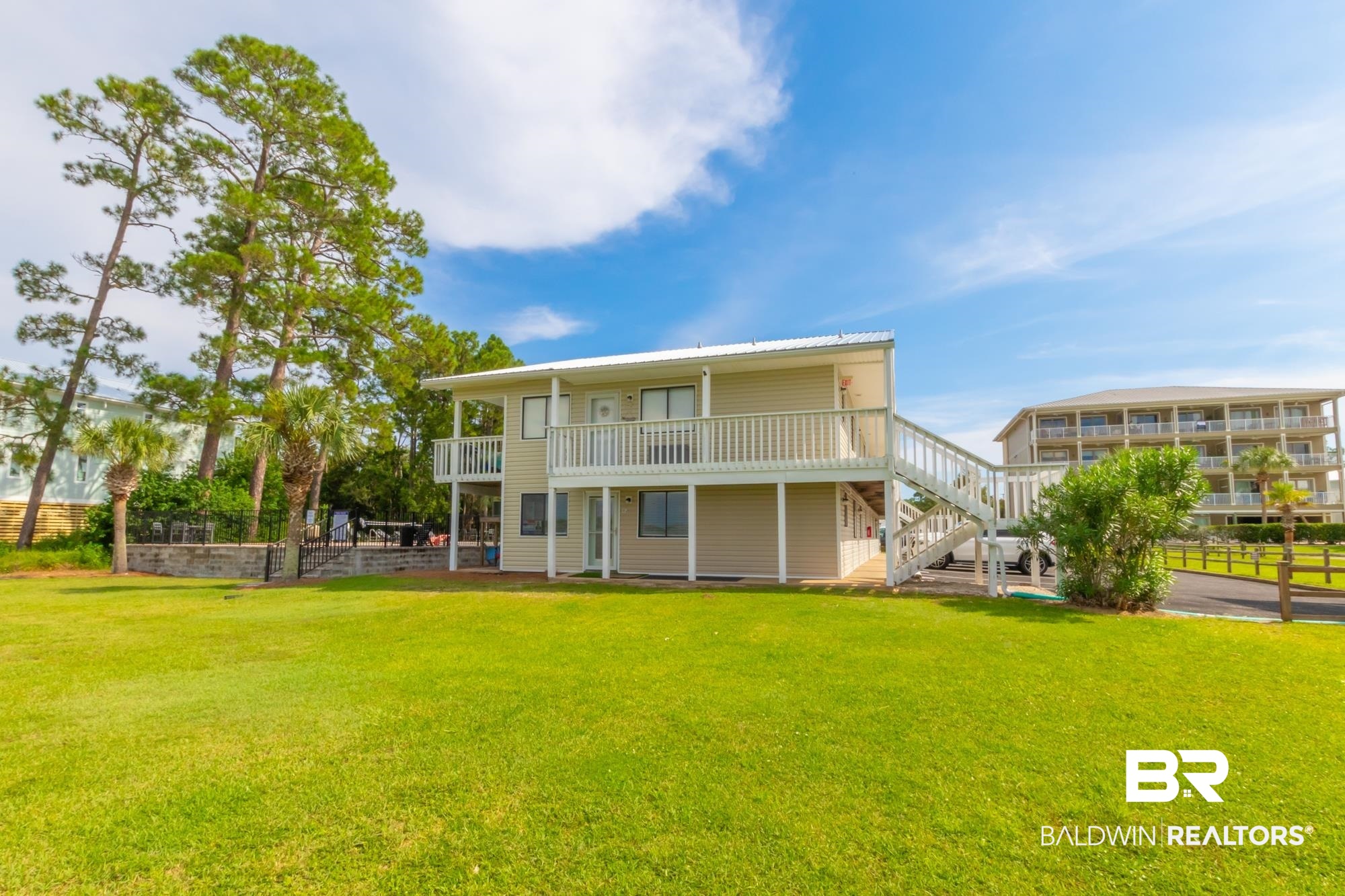 25925 -C Canal Road, Unit 203 Orange Beach, AL 36561 - Photo 49 of 57 Back of house featuring a lawn