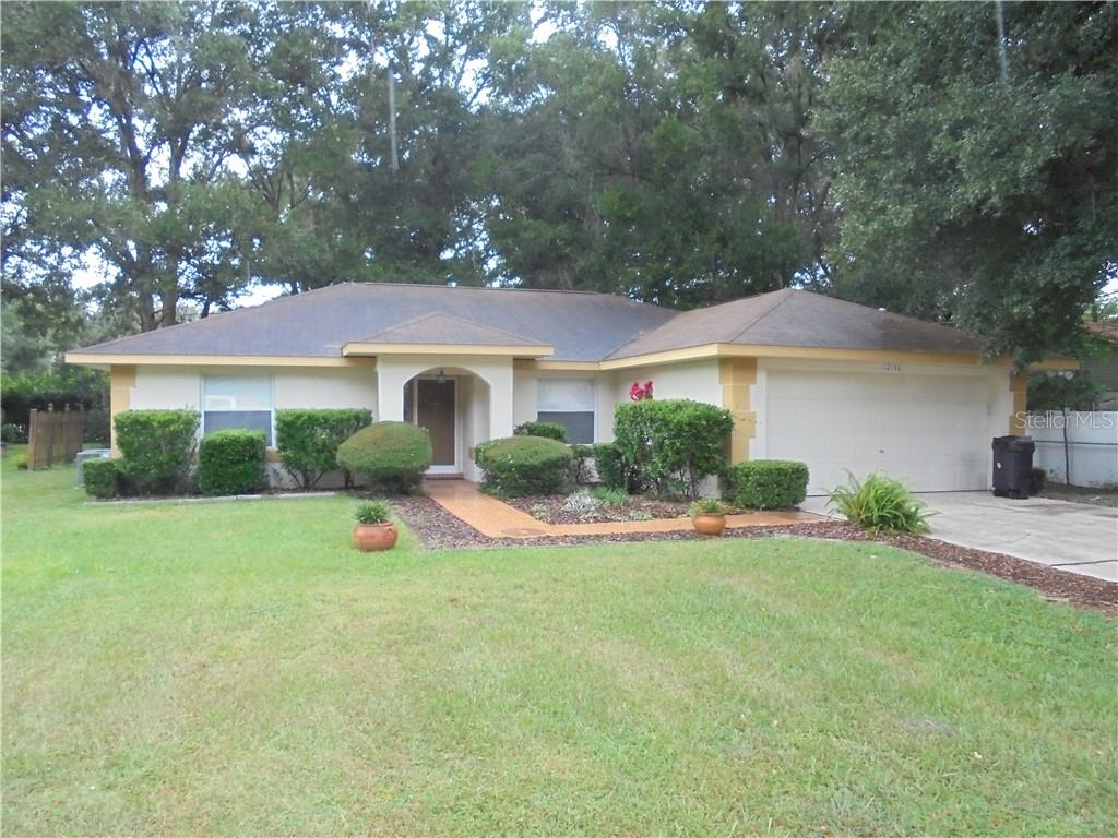 12146 Southeast 72nd Terrace Road Belleview, FL 34420 - Photo 1 of 1 a view of a house with a yard and plants