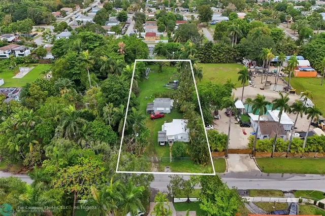 an aerial view of residential house with outdoor space and swimming pool