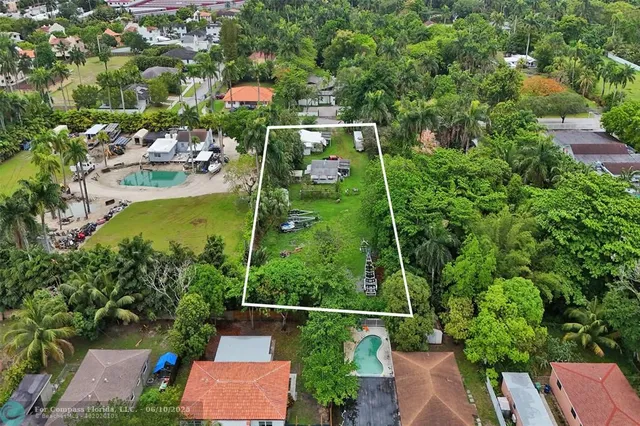 an aerial view of a residential houses with outdoor space and street view