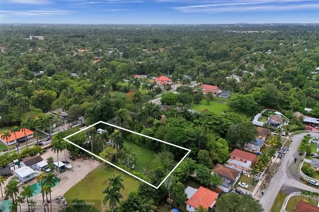 a view of a balcony with chairs and a potted plant