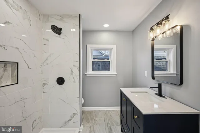 a kitchen with granite countertop a refrigerator stove top oven and sink