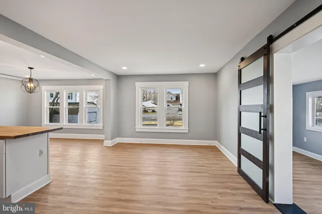 a kitchen with stainless steel appliances granite countertop a stove a sink dishwasher and a refrigerator with wooden floor