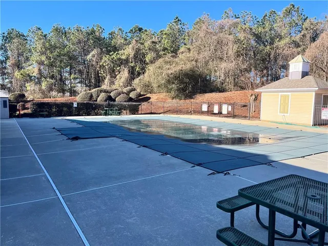 a view of swimming pool with seating space