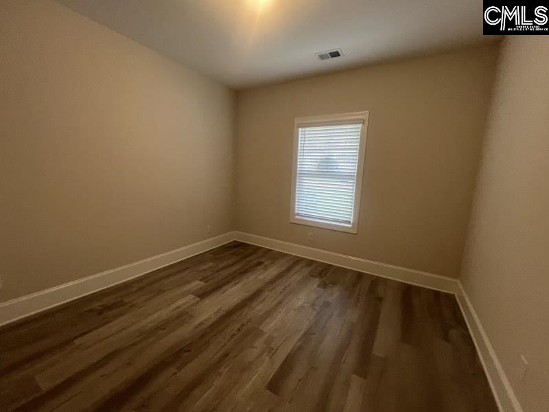 516 Mitscher Way Chapin, SC 29036 - Photo 6 of 18 an empty room with wooden floor and windows