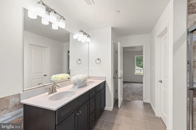 a bathroom with a sink vanity granite tub and shower