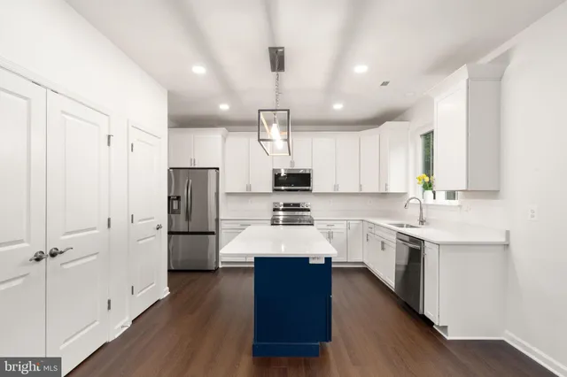 a large kitchen with cabinets and stainless steel appliances