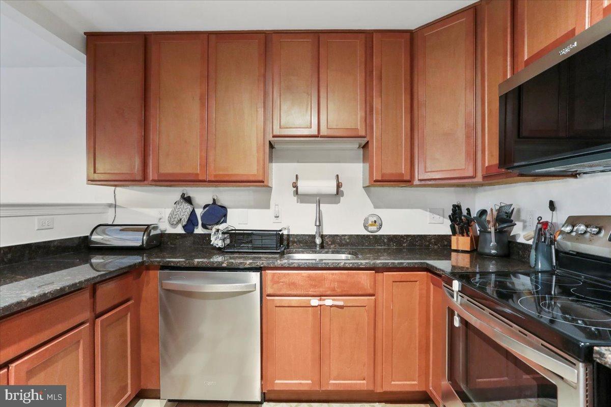 501 Prospect Boulevard Frederick, MD 21701 - Photo 11 of 27 a kitchen with granite countertop wooden cabinets and a stove top oven