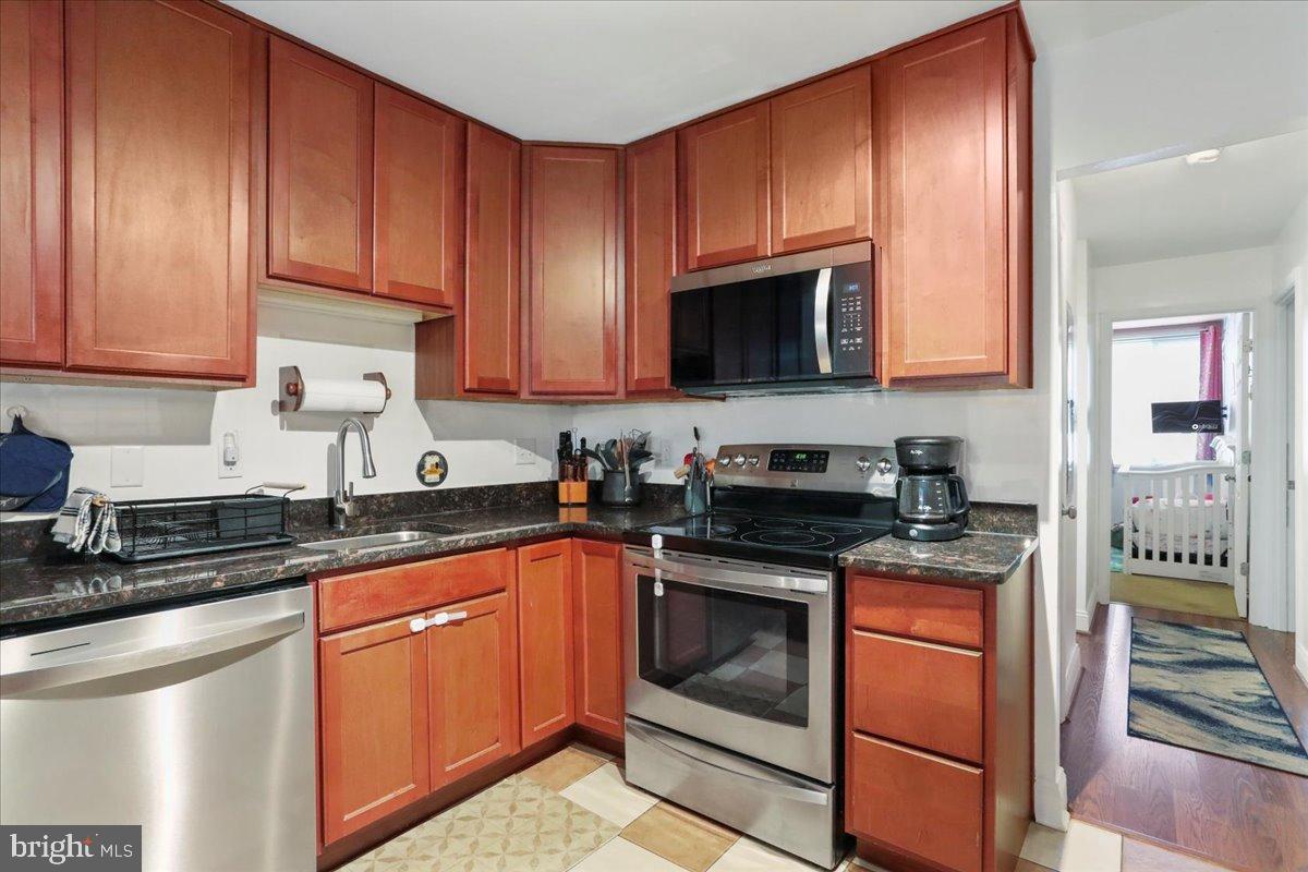 501 Prospect Boulevard Frederick, MD 21701 - Photo 12 of 27 a kitchen with stainless steel appliances granite countertop a stove sink microwave and refrigerator