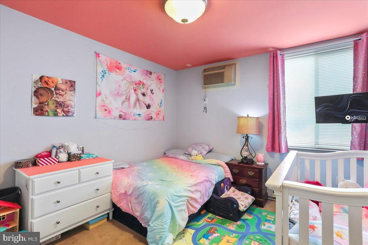 501 Prospect Boulevard Frederick, MD 21701 - Photo 4 of 27 a bedroom with a bed and a flat screen tv